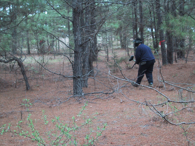 Player in dark clothing moving through the woods