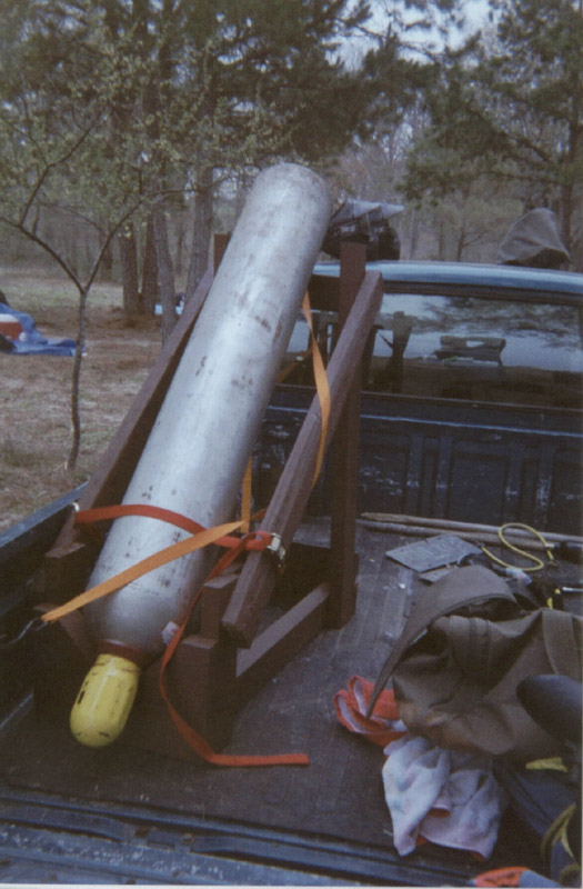 Equipment and a large cylinder beside a vehicle