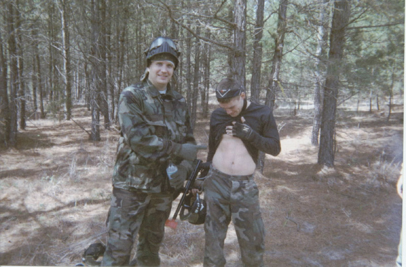 Two players posing with paintball equipment