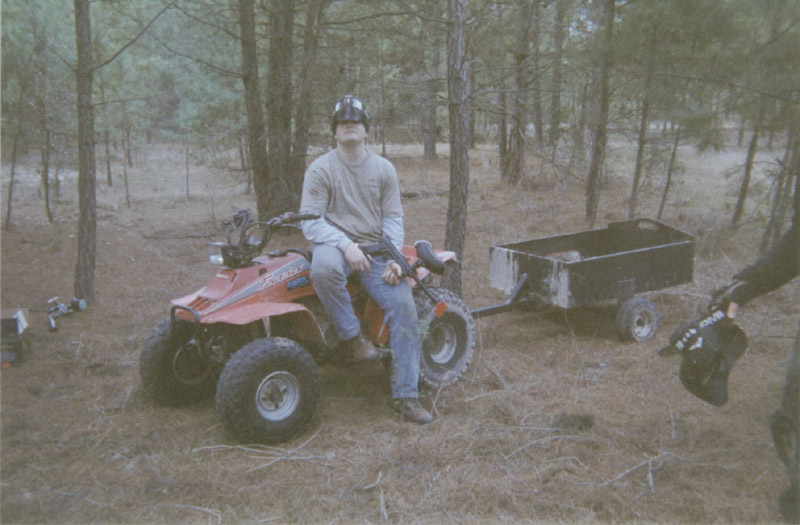 Person seated on an all-terrain vehicle at camp