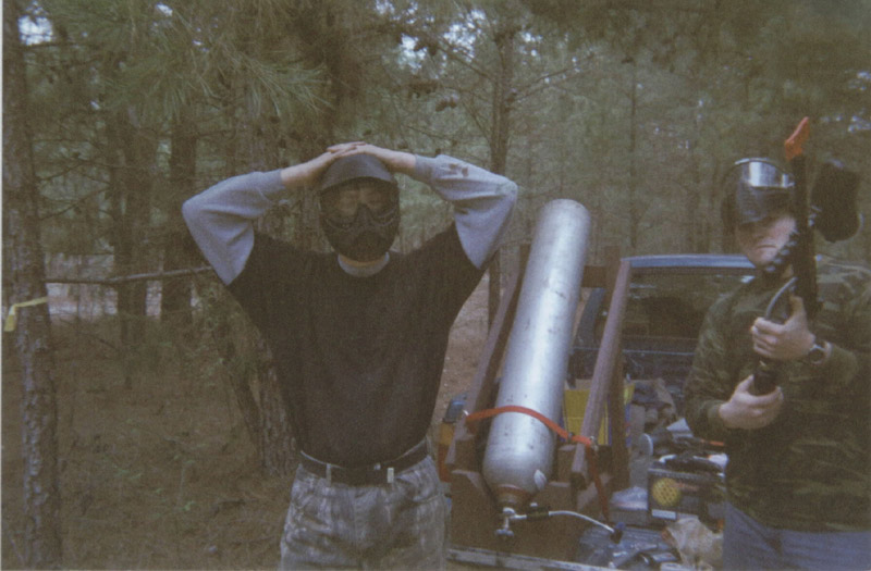 Person beside equipment with hands resting on their head