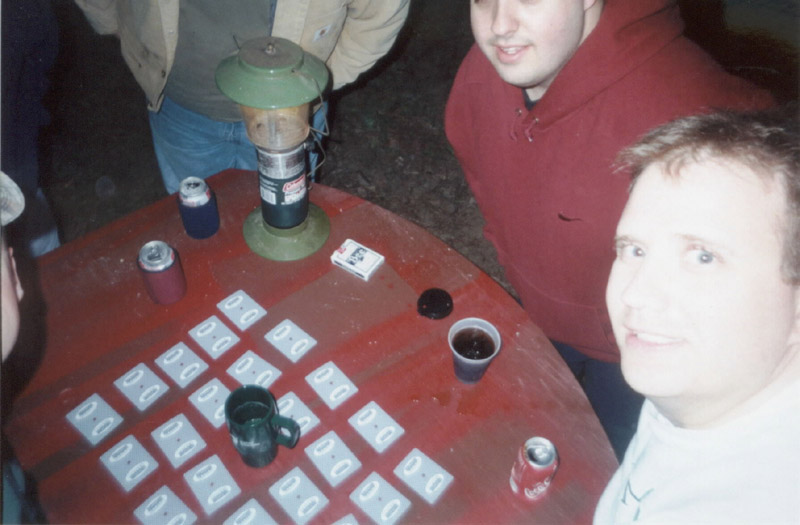 People gathered around cards on a table