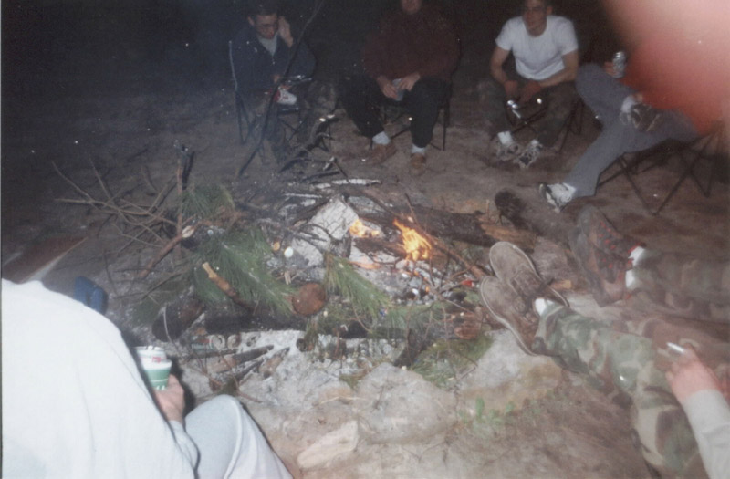 Close view of a campfire surrounded by chairs