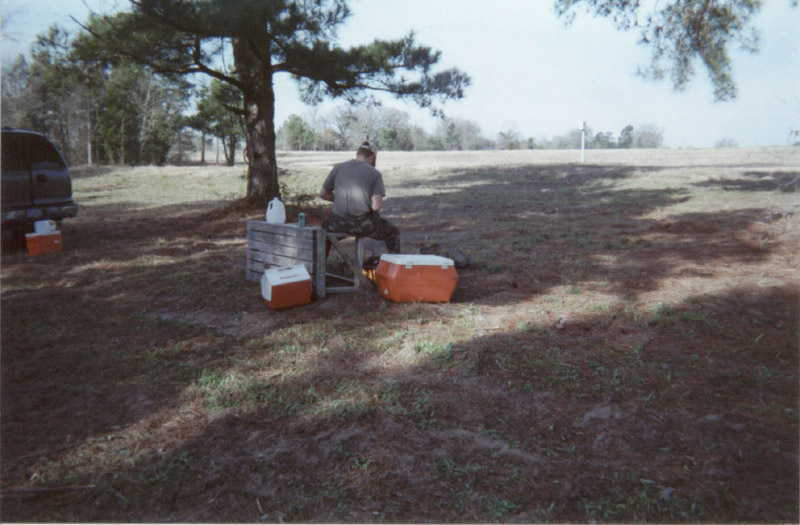 Coolers and camp supplies beneath a tree