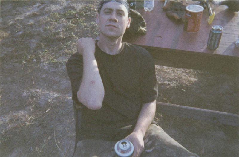 Seated camper holding a drink