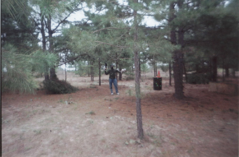 Player standing among pine trees and field cover