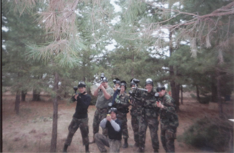 Group of paintball players posing in the woods