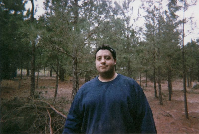 Portrait of a person in a blue shirt in the woods