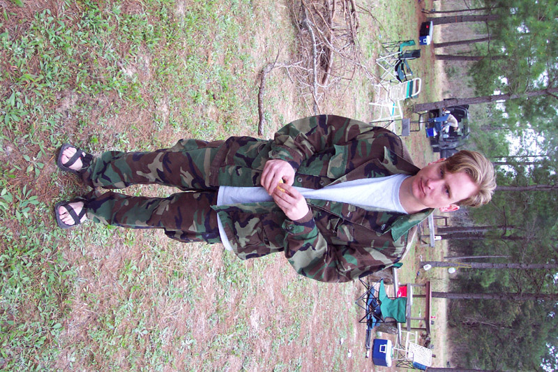 Camouflaged player standing at the woodland campsite