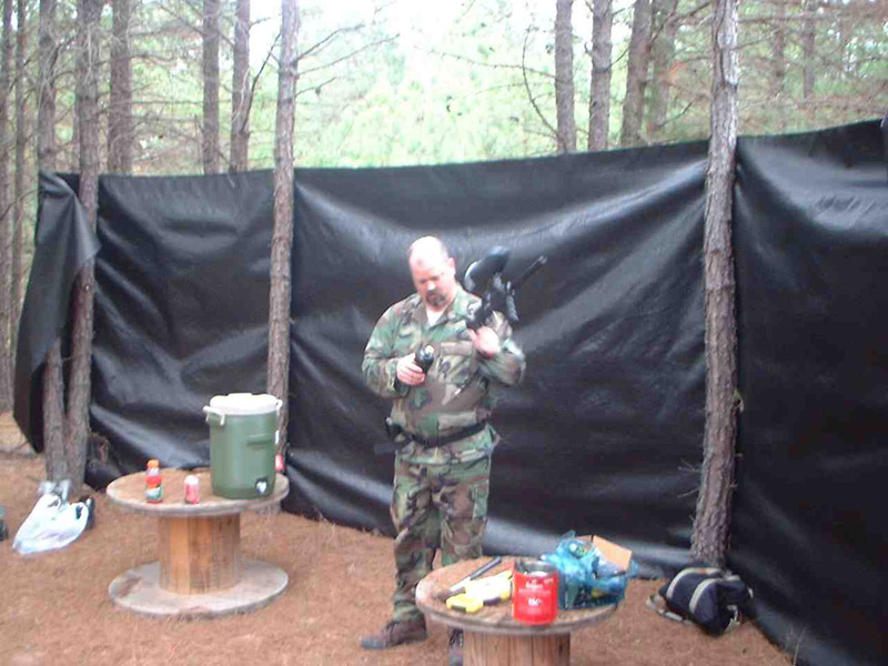 Player holding equipment in front of a black field screen