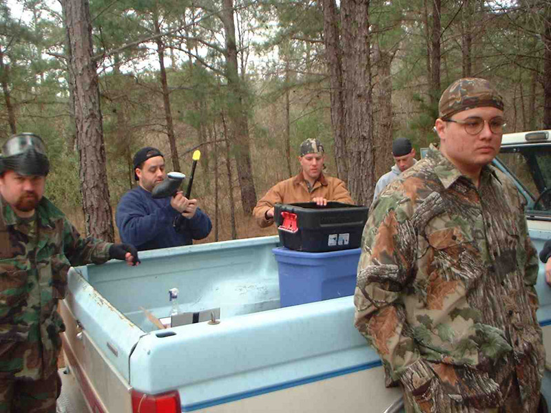 Players standing around a pickup truck bed