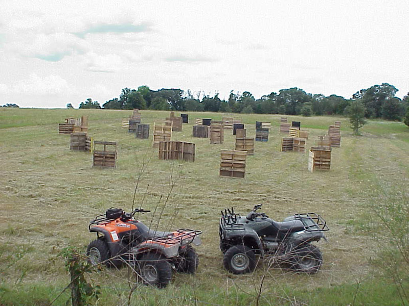 Two all-terrain vehicles overlooking an open playing field