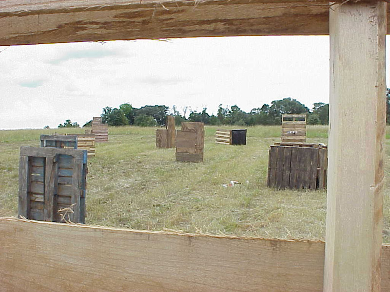 Wooden field barriers seen through an opening in cover