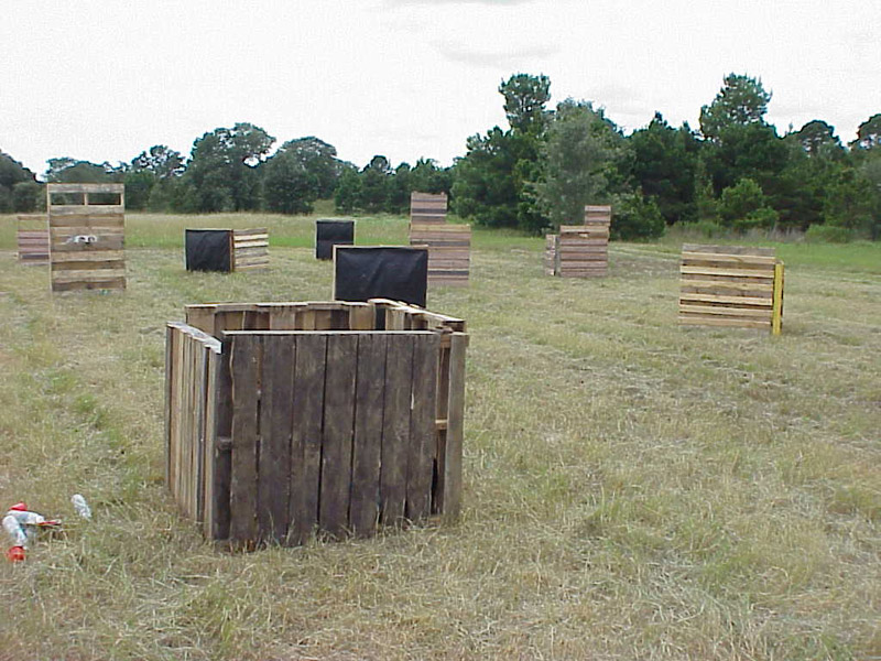 Wooden and dark-sided barriers on a grassy playing field